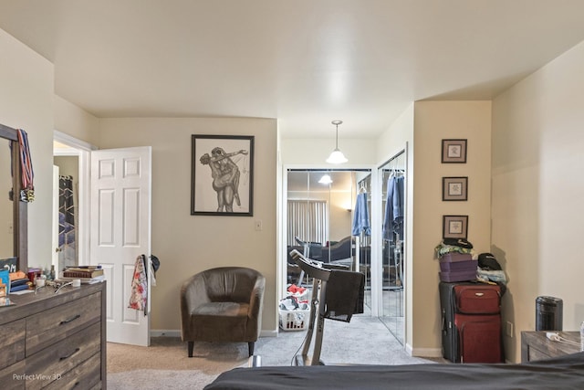 bedroom with light colored carpet and baseboards