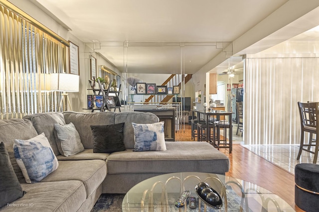 living room with stairs and wood finished floors