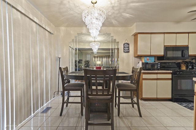 dining area featuring a chandelier and light tile patterned floors