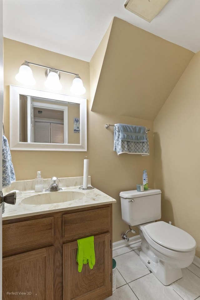 half bathroom with lofted ceiling, tile patterned flooring, toilet, vanity, and baseboards