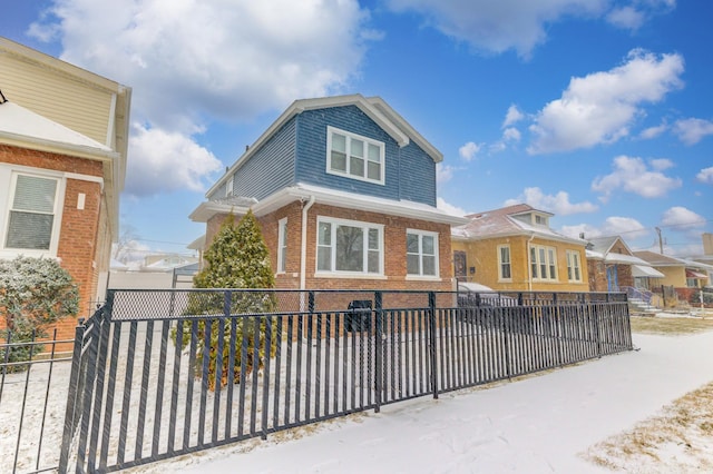 view of front of property with a fenced front yard and brick siding