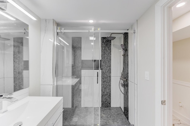 bathroom featuring marble finish floor, vanity, and a shower stall