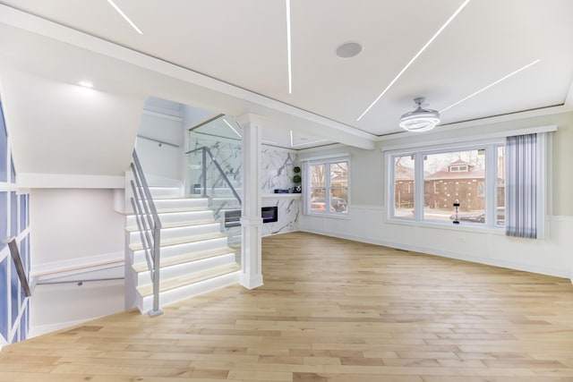 interior space featuring a high end fireplace and a ceiling fan