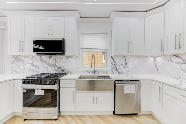 kitchen with black range with gas cooktop, a sink, white cabinetry, light stone countertops, and dishwasher