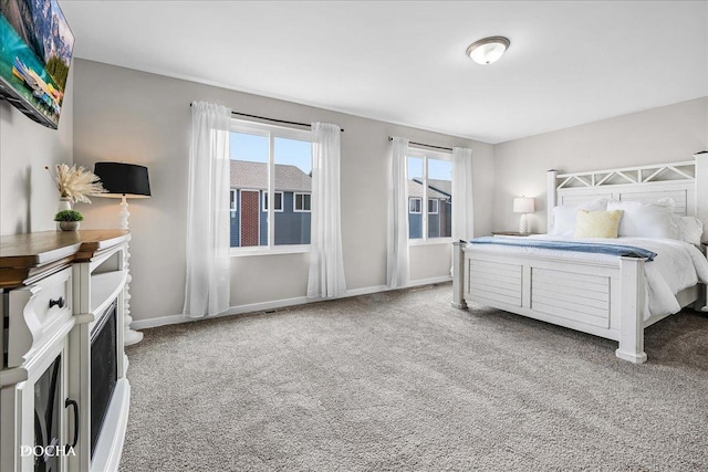 bedroom featuring carpet flooring and baseboards