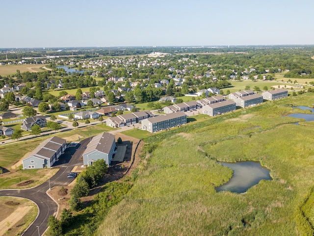 drone / aerial view with a water view and a residential view