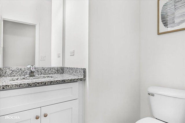 bathroom with toilet and vanity