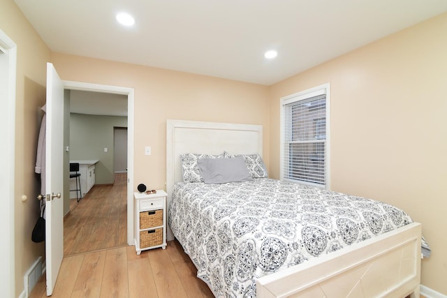 bedroom featuring baseboards, wood-type flooring, visible vents, and recessed lighting