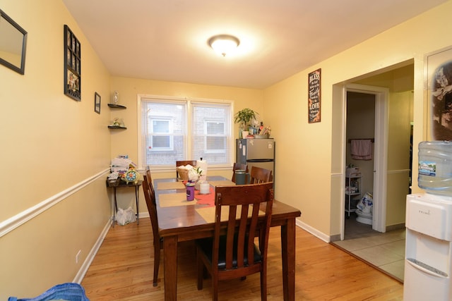 dining room with light wood-style flooring and baseboards