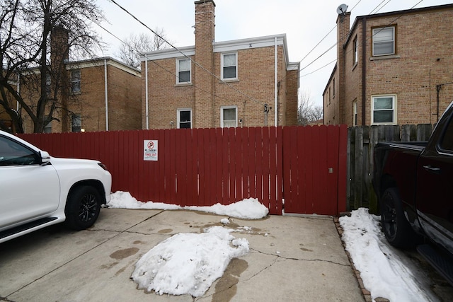 view of snow covered exterior featuring fence