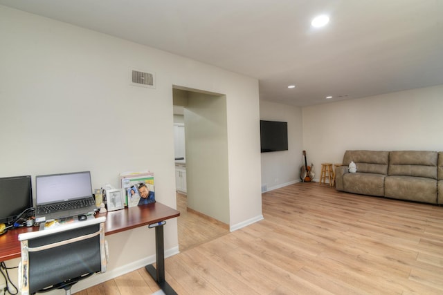 office space with recessed lighting, baseboards, visible vents, and light wood finished floors