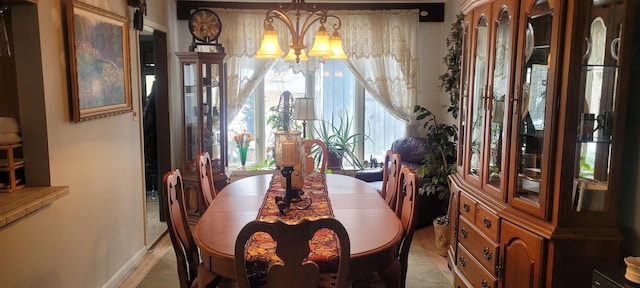 dining room with a chandelier and baseboards