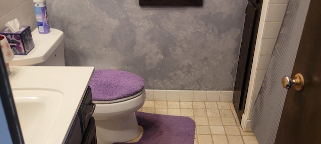 bathroom with toilet, a shower, and vanity