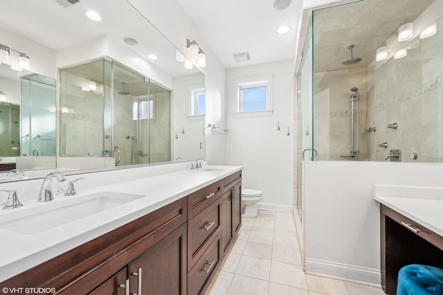 full bathroom with toilet, a shower stall, visible vents, and a sink