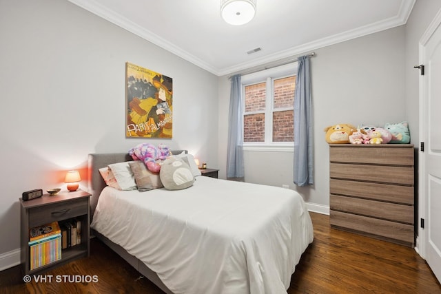 bedroom with baseboards, visible vents, dark wood finished floors, and crown molding