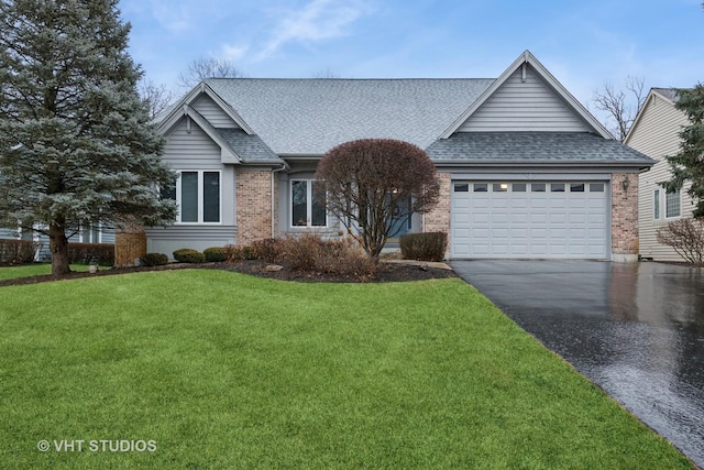 single story home featuring brick siding, a shingled roof, and a front yard