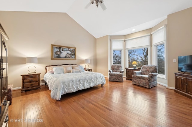 bedroom featuring wood-type flooring, high vaulted ceiling, ceiling fan, and baseboards