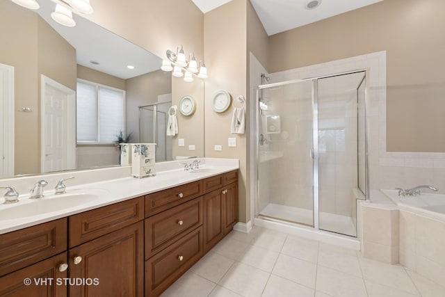 full bathroom with a garden tub, tile patterned flooring, a sink, and a shower stall