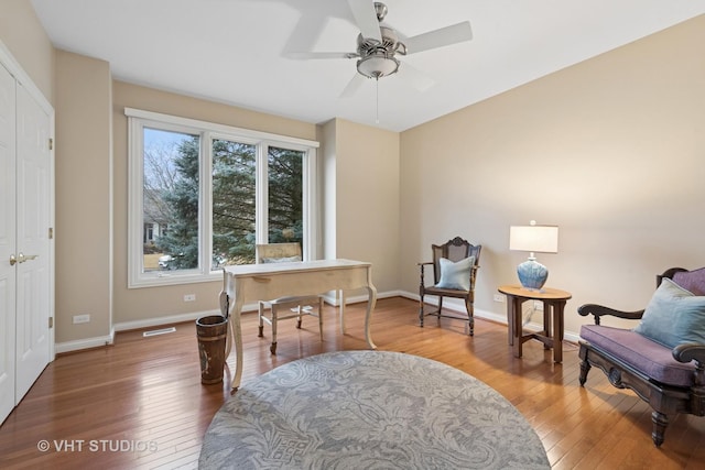 office area featuring ceiling fan, wood-type flooring, visible vents, and baseboards