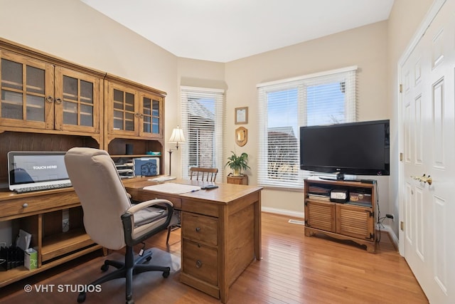 office area with light wood finished floors and baseboards