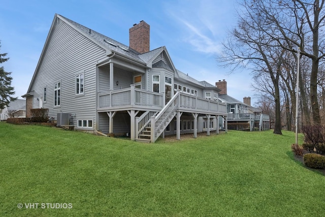 back of house featuring a deck, a yard, stairway, and central AC