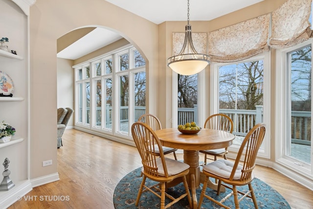 dining area featuring light wood-type flooring and baseboards