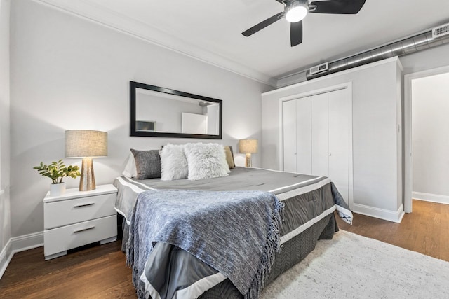 bedroom with ceiling fan, a closet, baseboards, and dark wood-type flooring