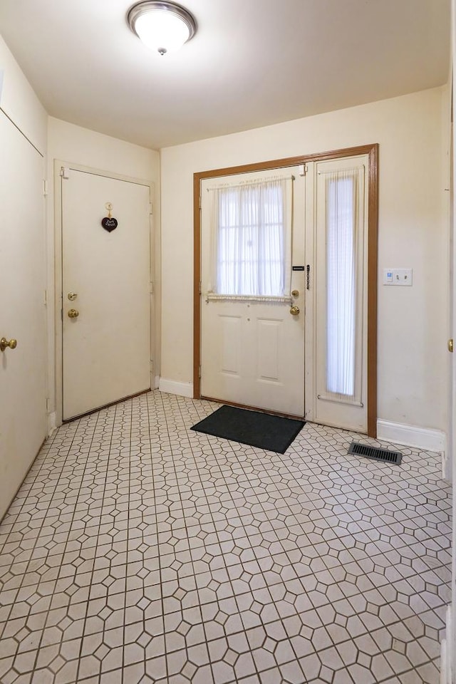 entrance foyer with light floors, visible vents, and baseboards