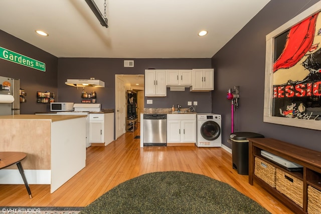 kitchen with dishwasher, white microwave, washer / dryer, and white cabinetry