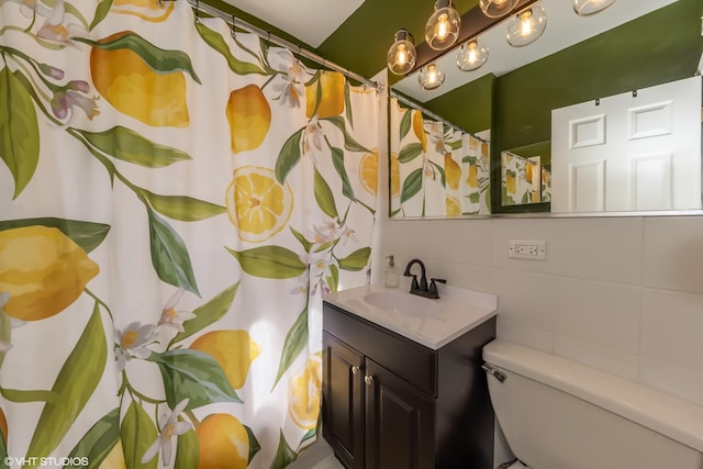 bathroom featuring tile walls, toilet, and vanity