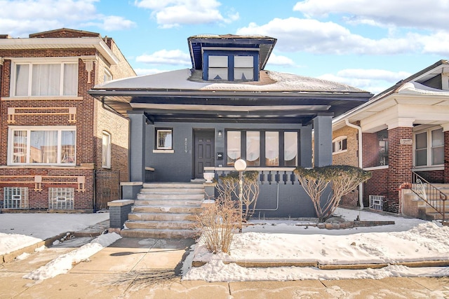 view of front of house with a porch and brick siding