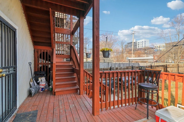 deck featuring fence and stairway