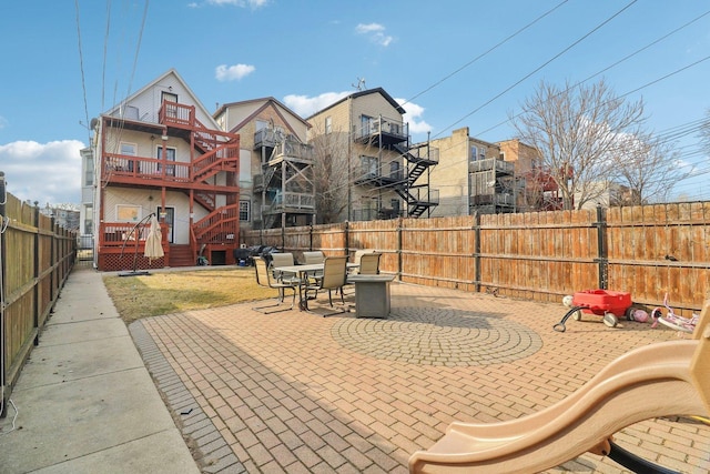 view of patio with outdoor dining space and a fenced backyard