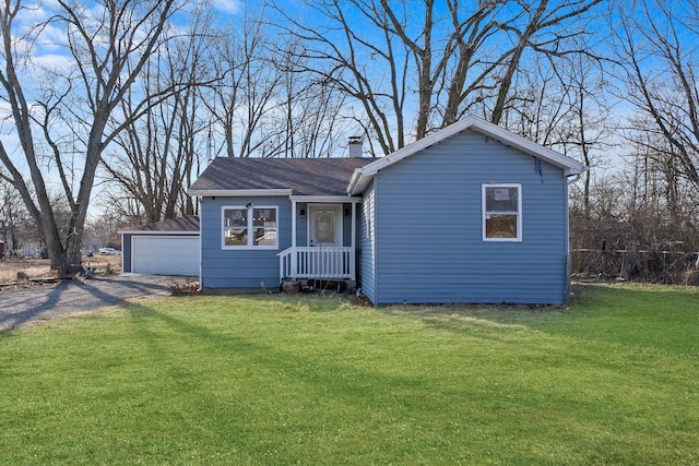 view of front of property featuring a chimney, fence, and a front yard