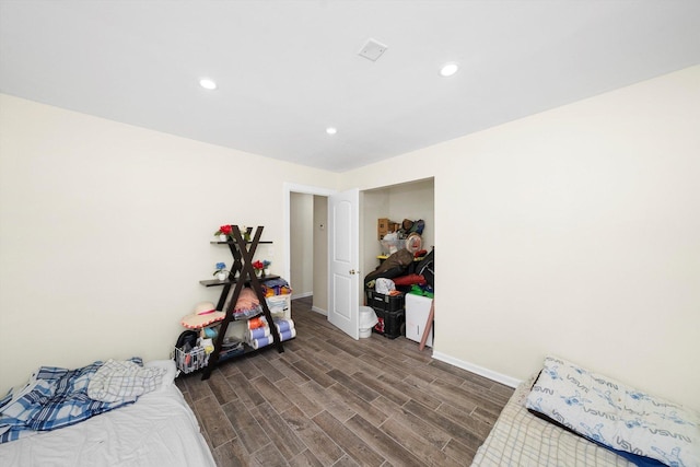 bedroom with dark wood-style floors, baseboards, and recessed lighting