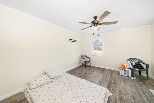 unfurnished bedroom featuring baseboards, ceiling fan, wood finished floors, and crown molding