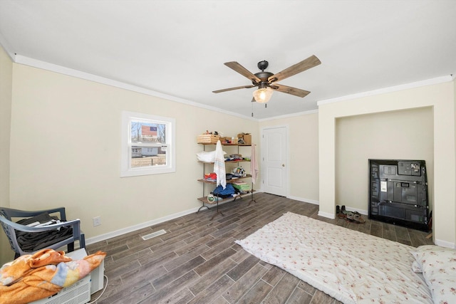 interior space featuring crown molding, baseboards, visible vents, and wood tiled floor