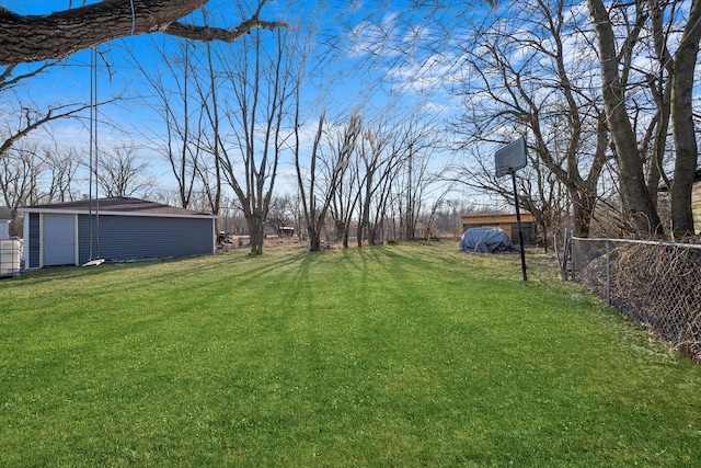 view of yard with an outbuilding and fence