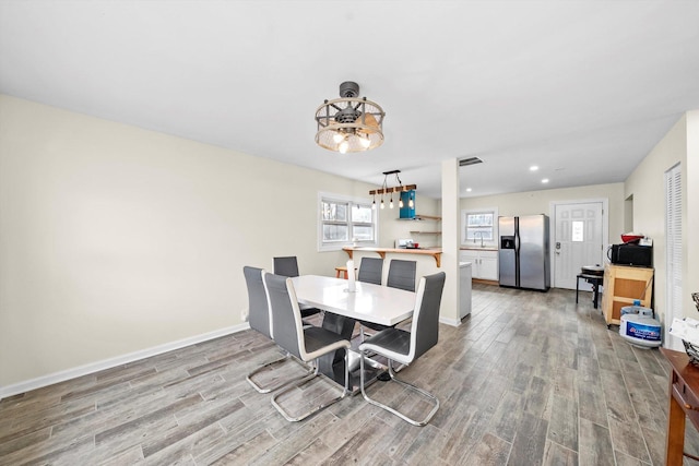 dining space with recessed lighting, visible vents, light wood-style flooring, and baseboards