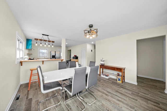 dining room with wood tiled floor and baseboards