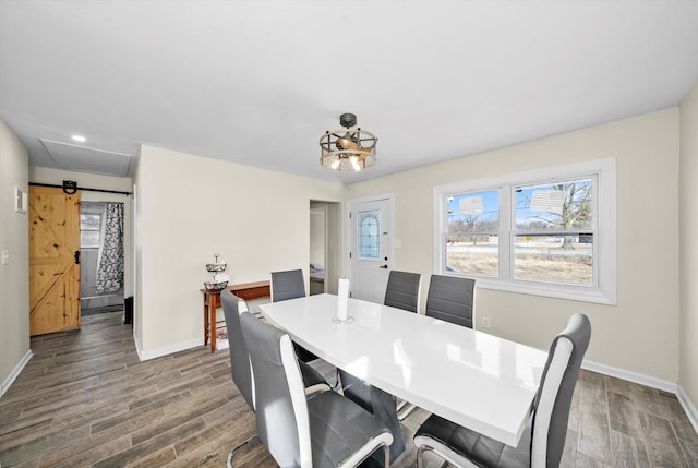 dining space featuring baseboards and wood finished floors