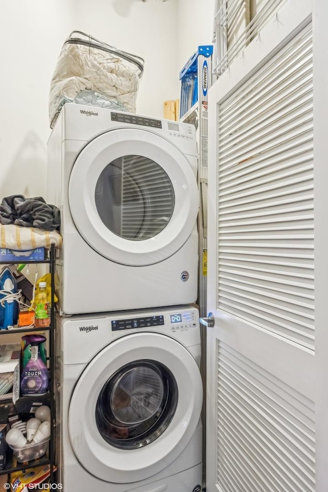 laundry area featuring stacked washing maching and dryer and laundry area