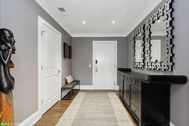 entrance foyer with recessed lighting, visible vents, ornamental molding, light wood-type flooring, and baseboards