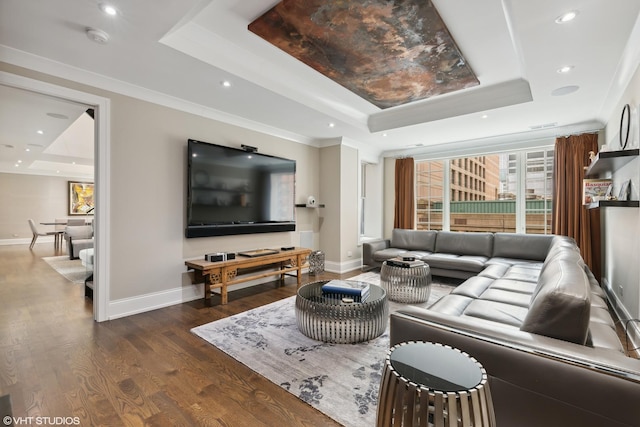 living room with dark wood-style floors, baseboards, a raised ceiling, and crown molding