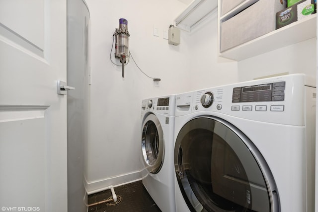 washroom featuring laundry area, independent washer and dryer, and baseboards