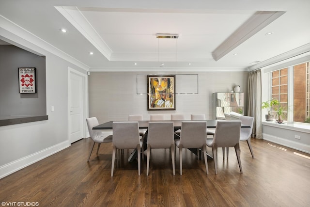 dining area featuring dark wood-type flooring, a tray ceiling, and baseboards