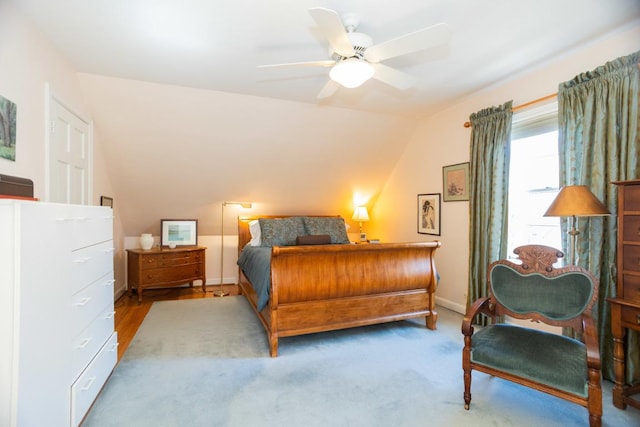 bedroom with vaulted ceiling, a ceiling fan, and baseboards