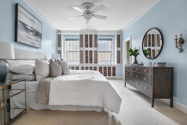 bedroom featuring baseboards, ornamental molding, a ceiling fan, and light colored carpet