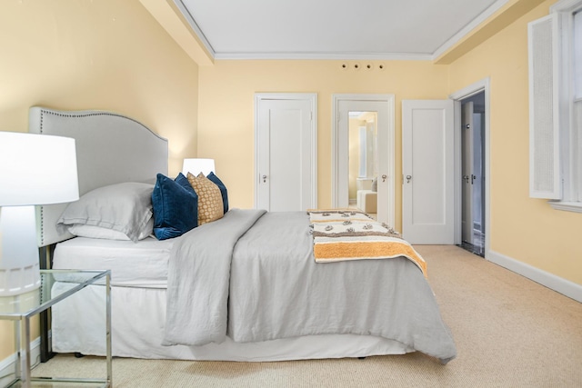 carpeted bedroom featuring baseboards and crown molding