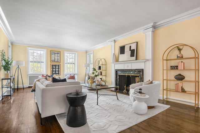 living room with dark wood-type flooring, ornamental molding, baseboards, and a premium fireplace